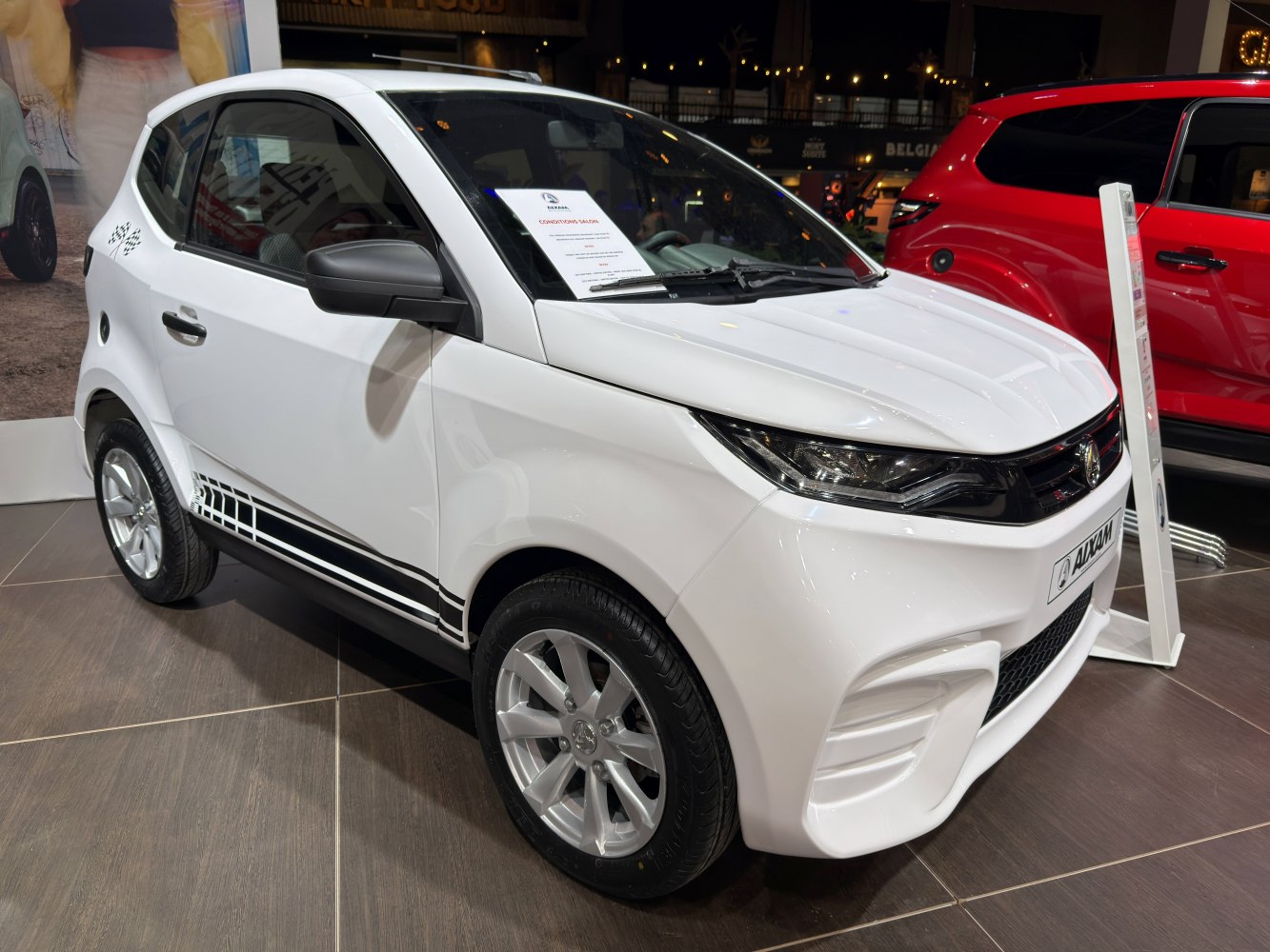 Compact urban microcar front-side view with sporty decals