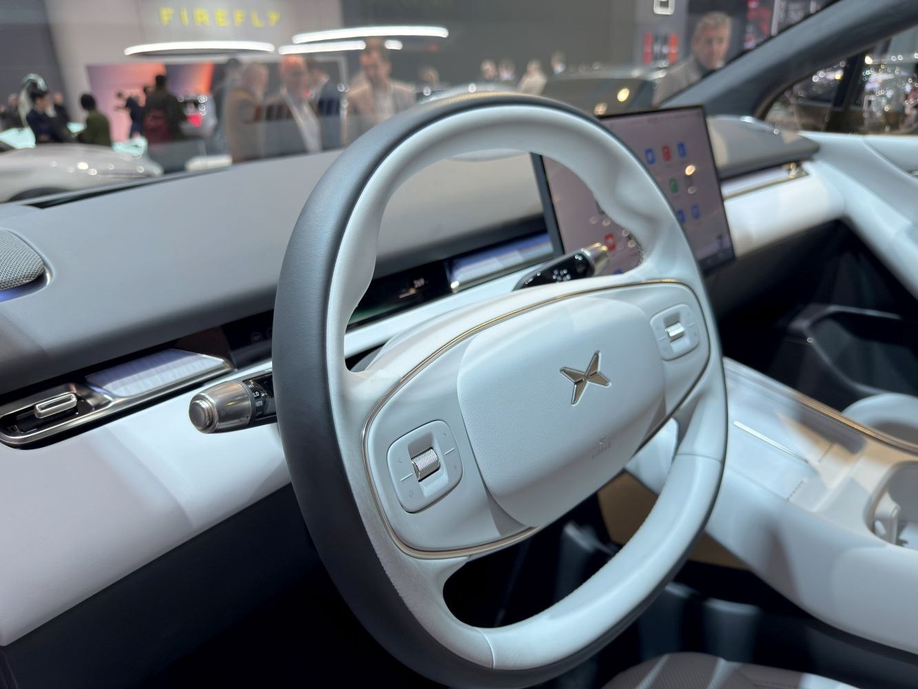 Electric steering wheel with dual controls and digital dashboard display.