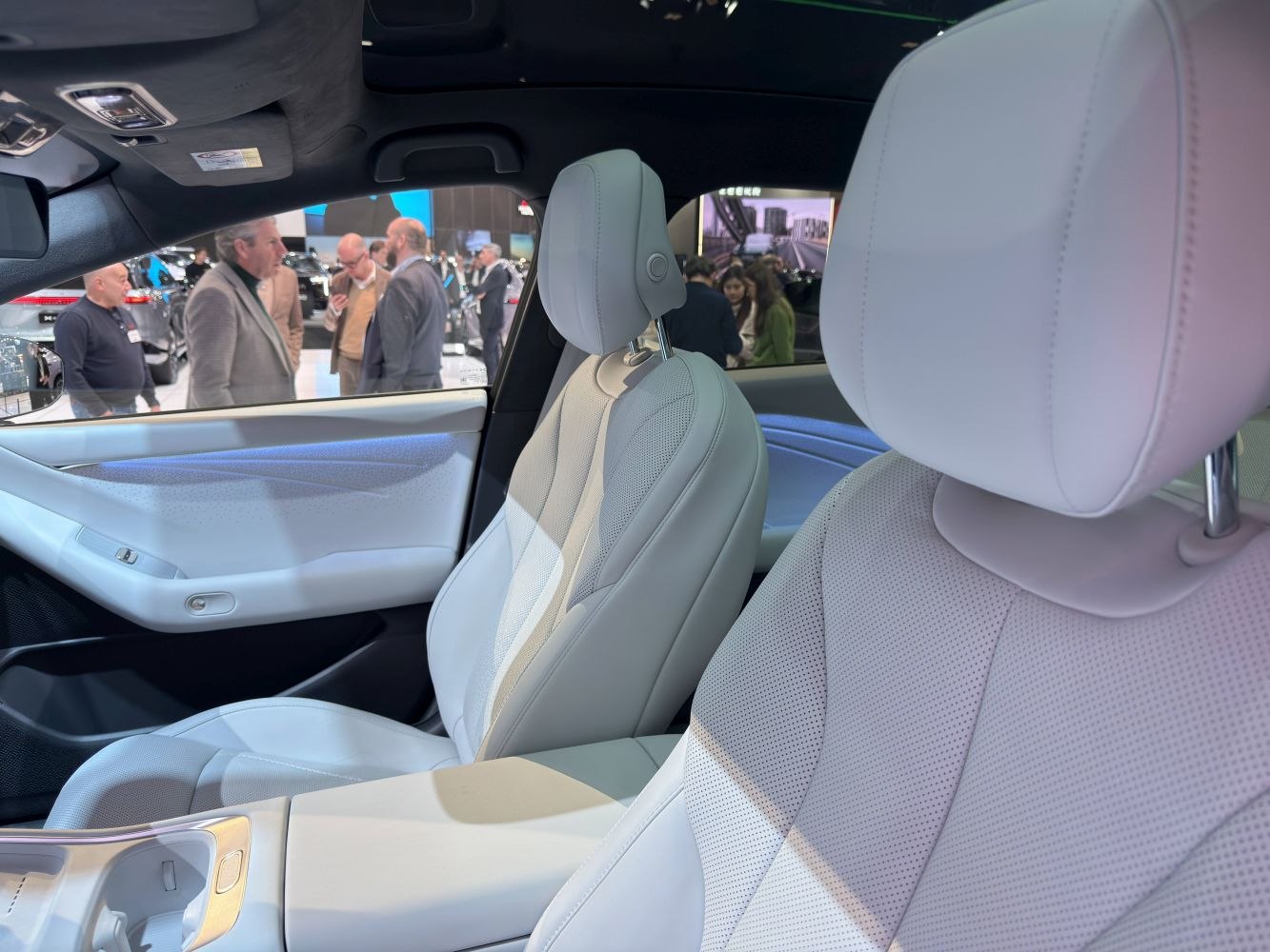 White leather luxury seats and modern door panel interior.