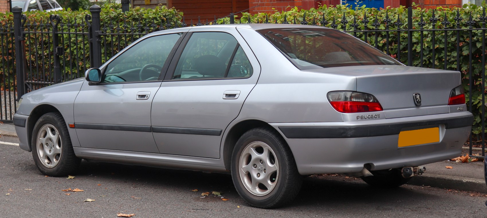 Silver sedan rear side view with alloy wheels and classic 1990s styling