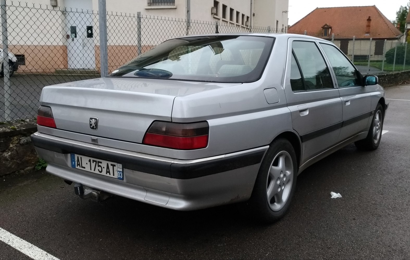 Silver sedan rear view with distinct tail lights and body lines