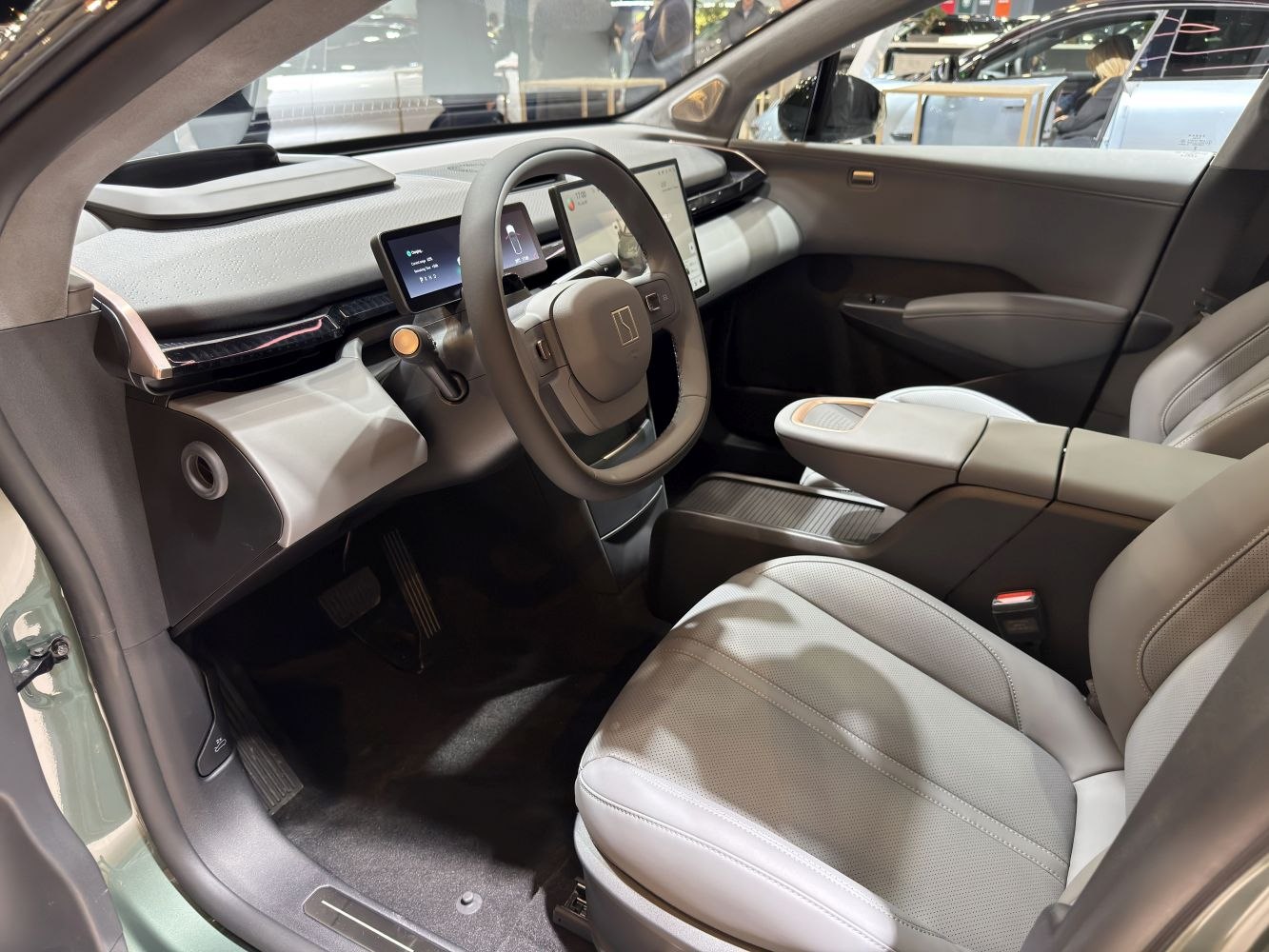 Dual digital screens and modern steering wheel in a sleek interior setup