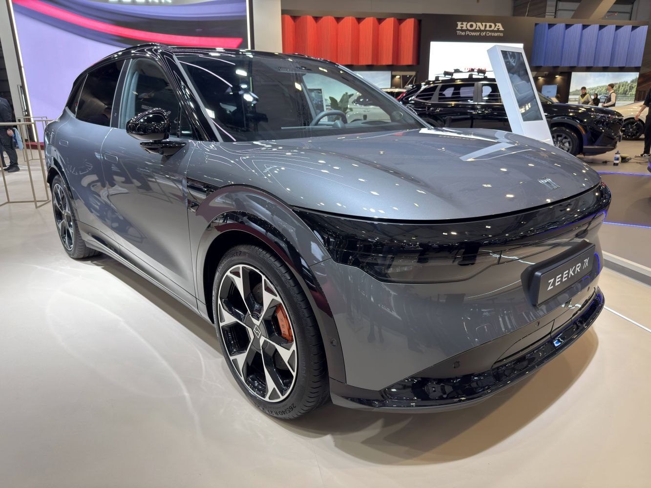Aerodynamic electric SUV with sleek LED headlights and distinctive wheels