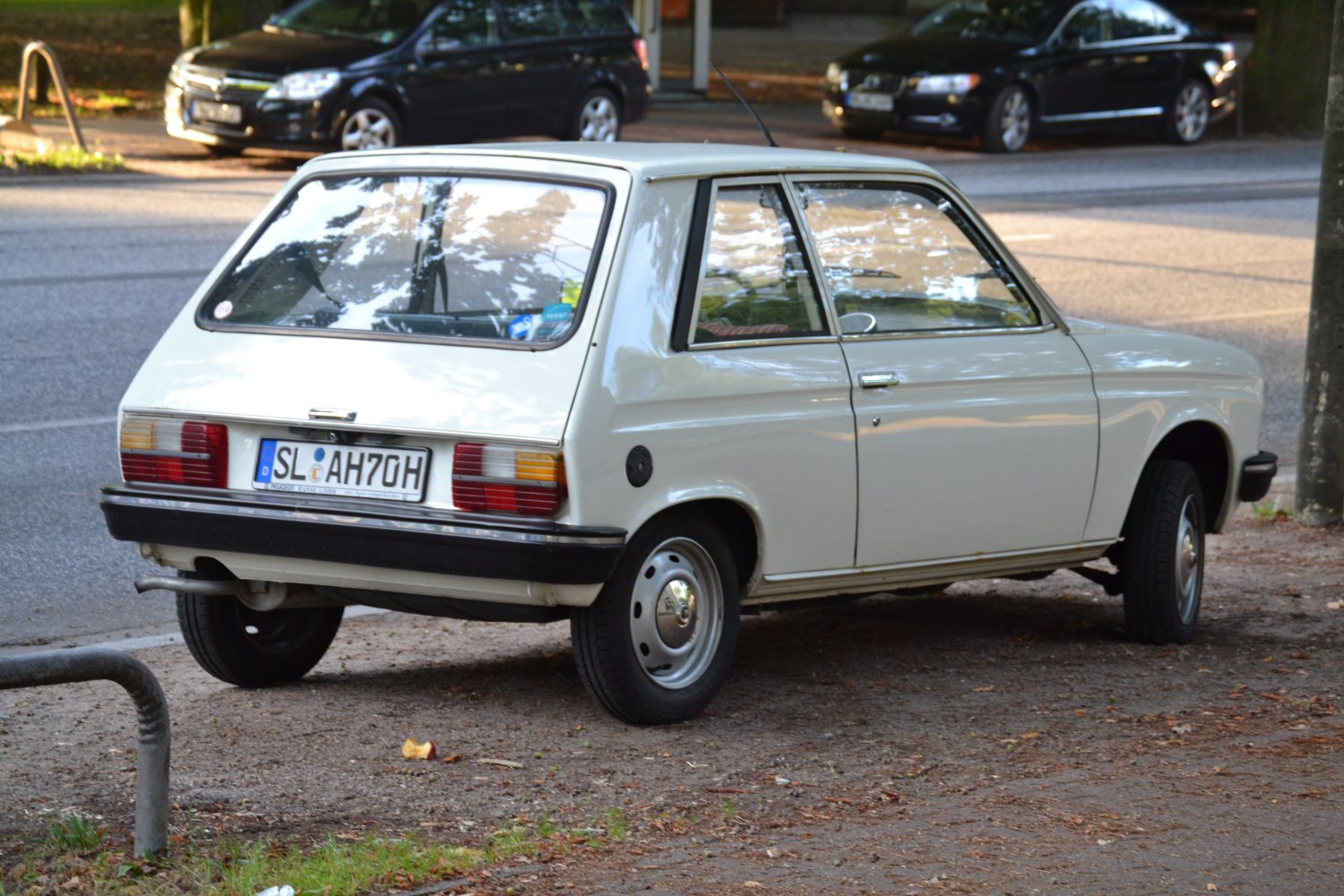 Rear and side view of a vintage compact hatchback.