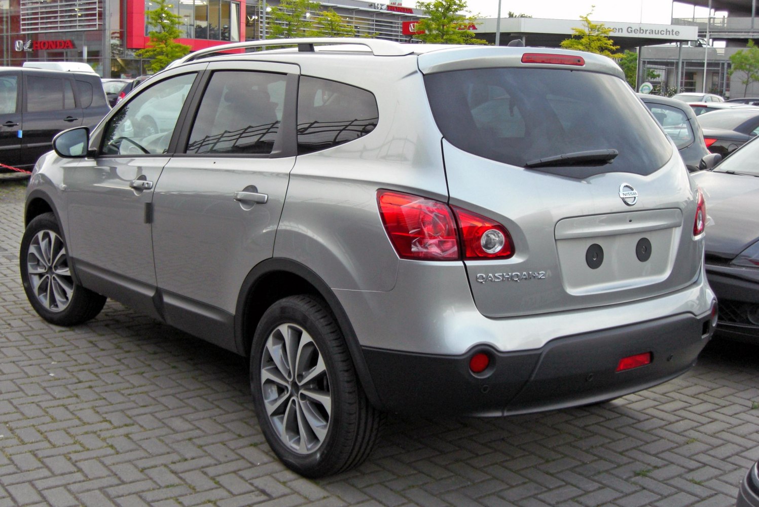 Silver SUV rear and side view with distinctive tail lights and roof rails