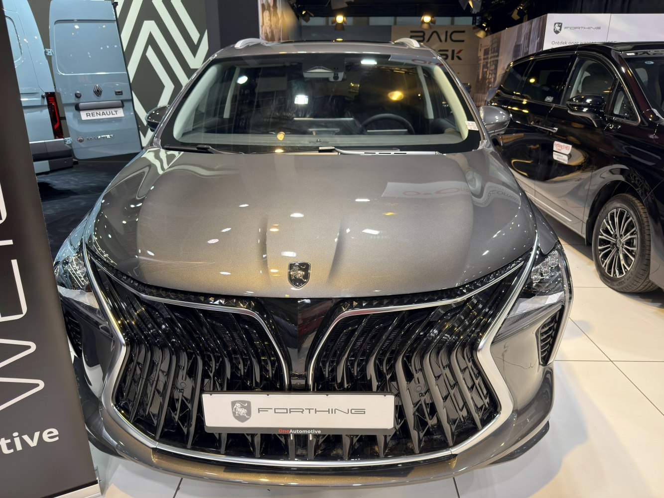 Bold front grille and sleek hood design with badge