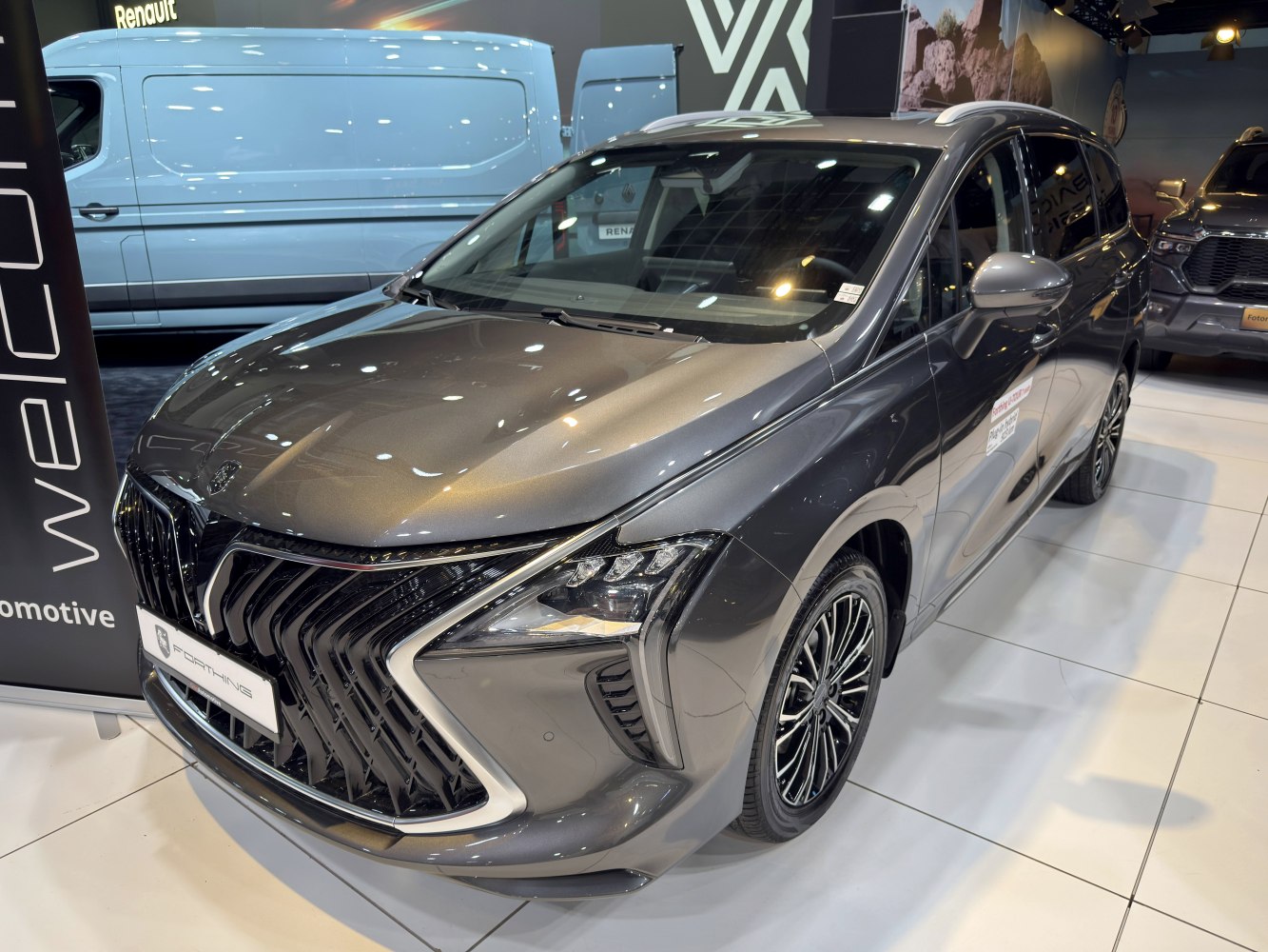 Large black front grille with angular headlights and a sleek front fascia.