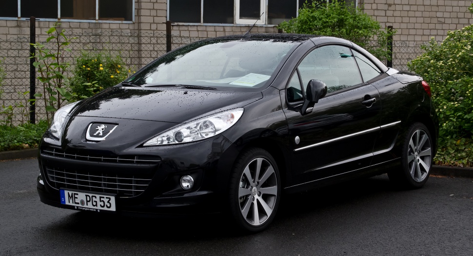 Front side view of a black Peugeot 207 CC with sleek headlights and alloy wheels