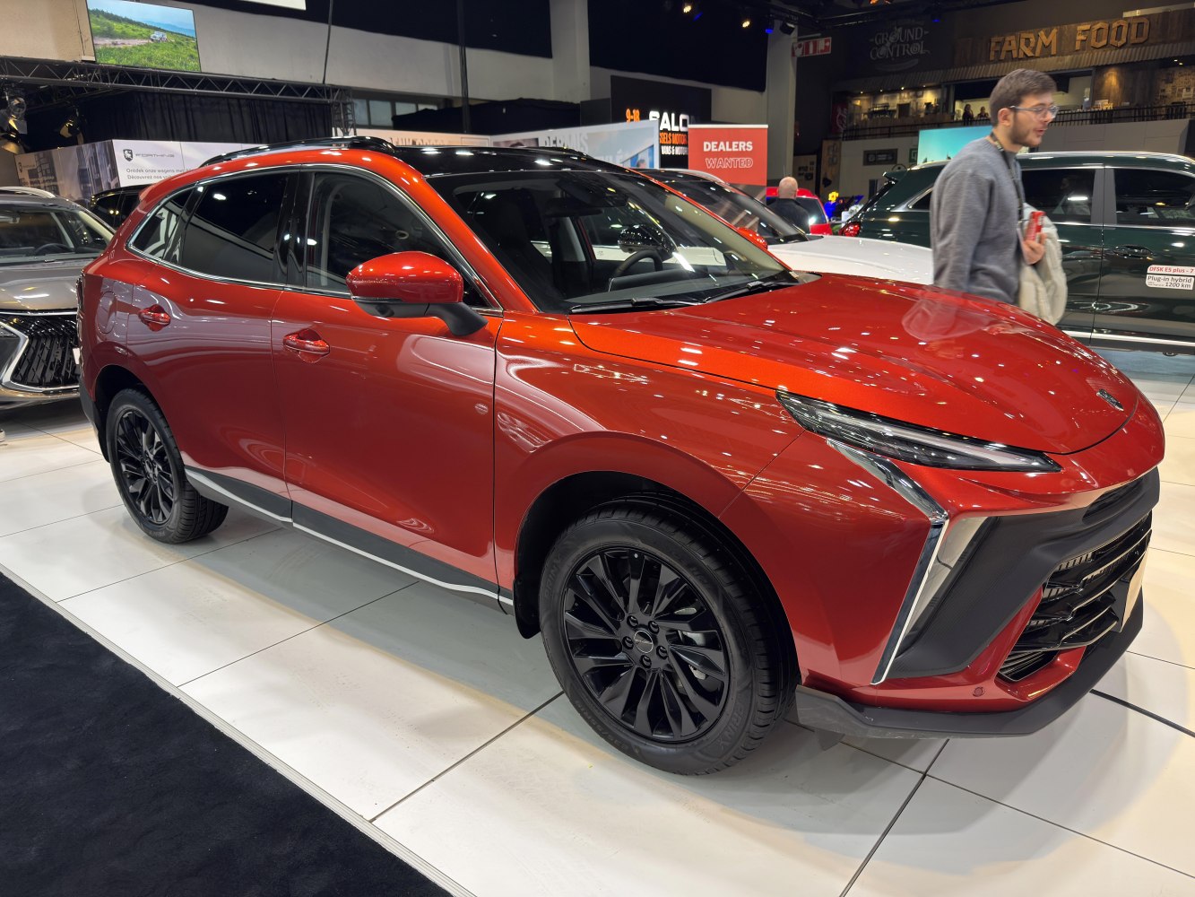 Red SUV with sleek headlights and black alloy wheels