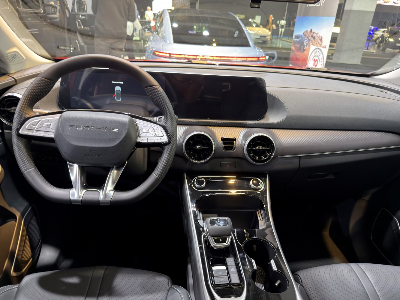 Digital dashboard, dual circular air vents, modern center console with shifter