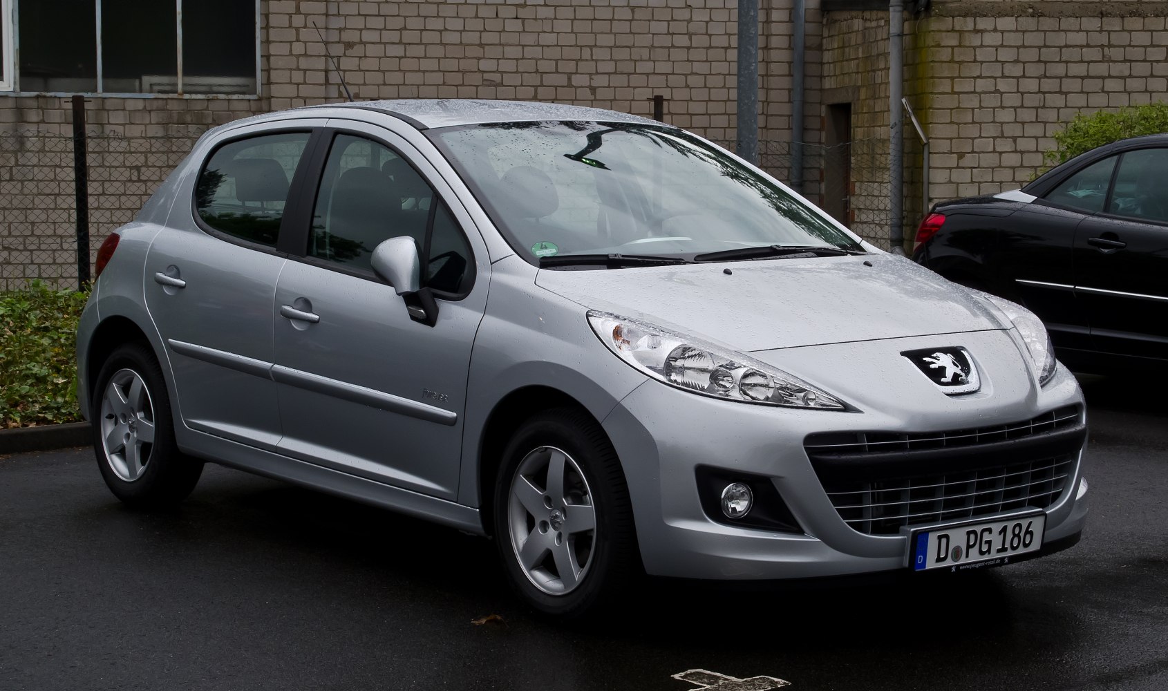 Front and side profile of a compact hatchback with prominent headlights and grille