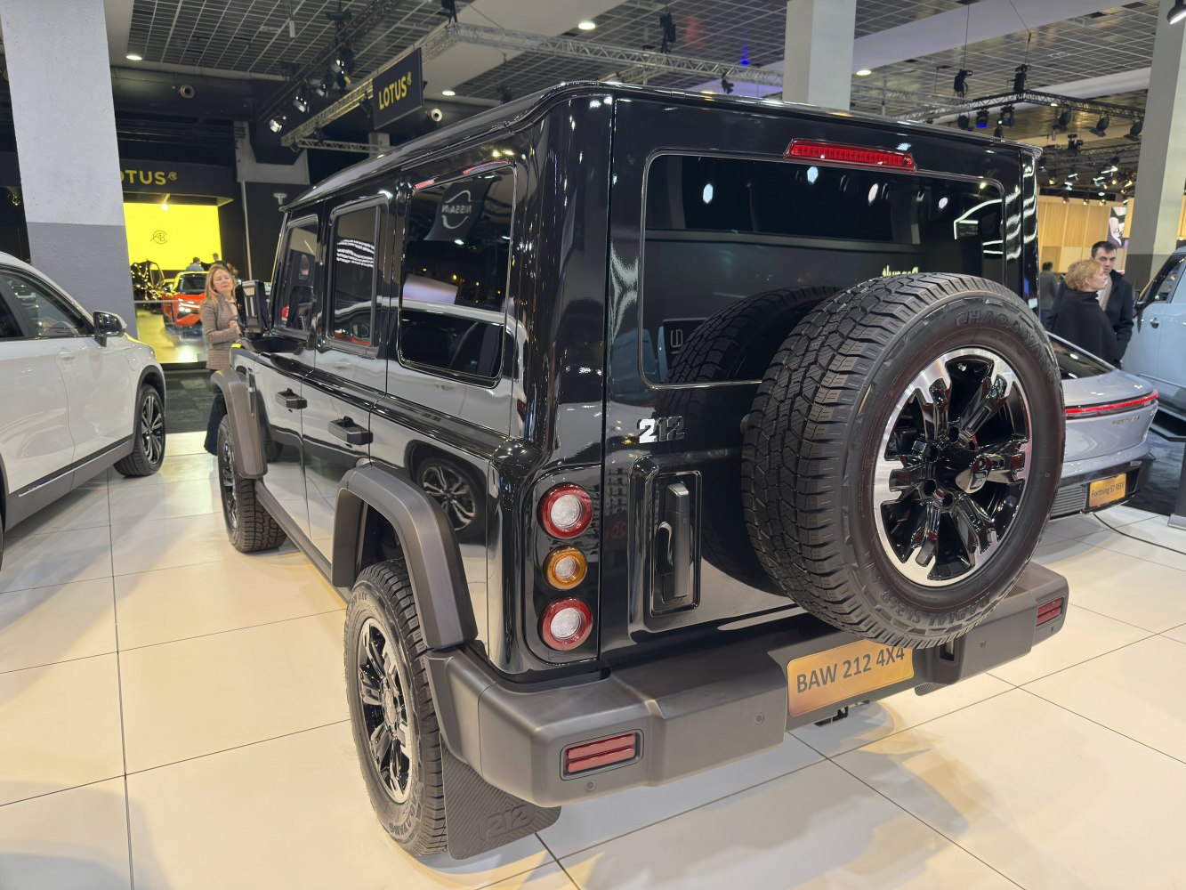 SUV rear view with spare tire mounted on tailgate and modern taillights