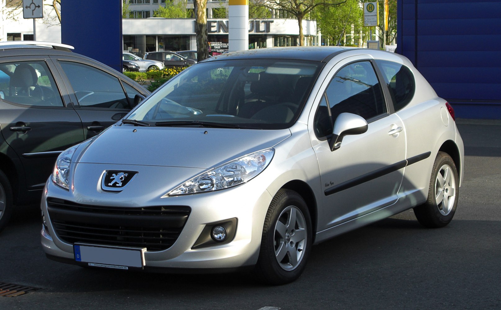 Silver hatchback front three-quarter view with headlights and grille