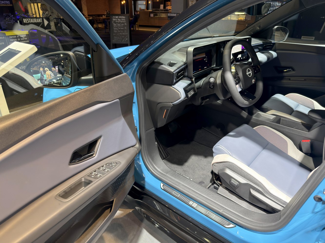 Modern car interior with digital cockpit and ergonomic seats.