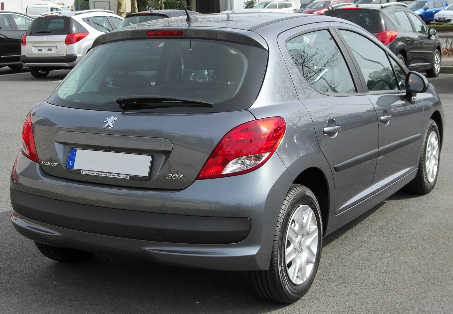 Rear hatchback view with distinct taillights and rear windshield wiper