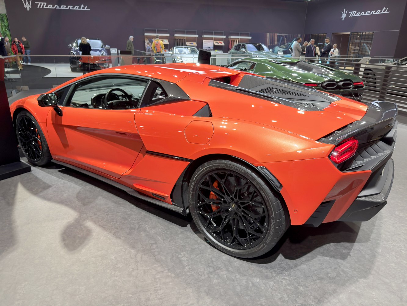 Rear side profile of a sleek sports coupe with black alloy wheels and aerodynamic design