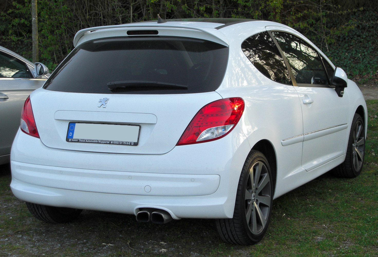 Rear view hatchback with dual exhaust and rear spoiler