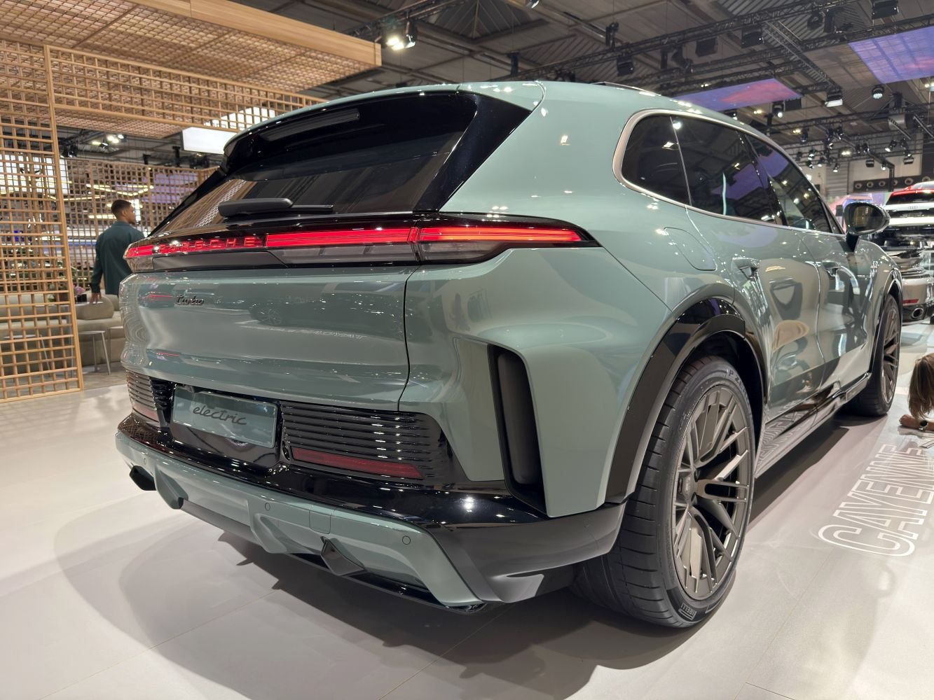 Electric SUV rear with continuous LED taillights and large alloy wheels