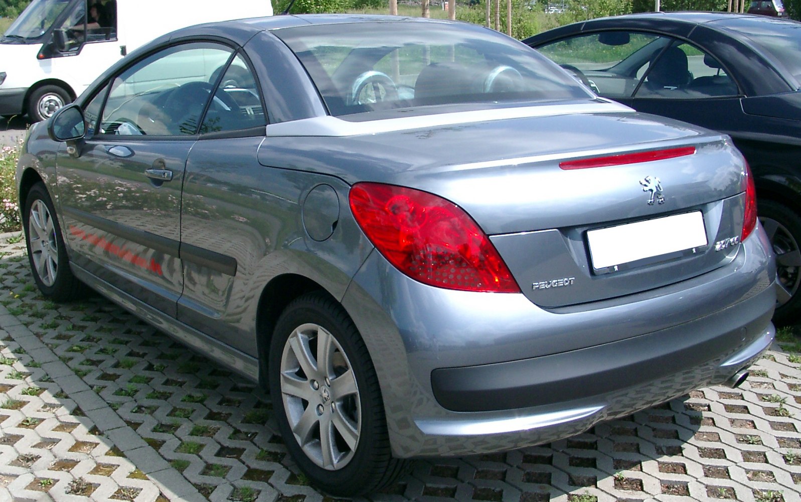 Silver convertible coupe rear with taillights and alloy wheels