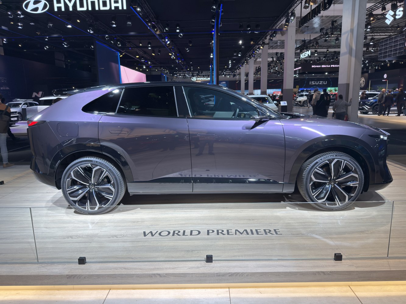 Side profile of sleek electric SUV with modern aerodynamic design and distinctive wheels