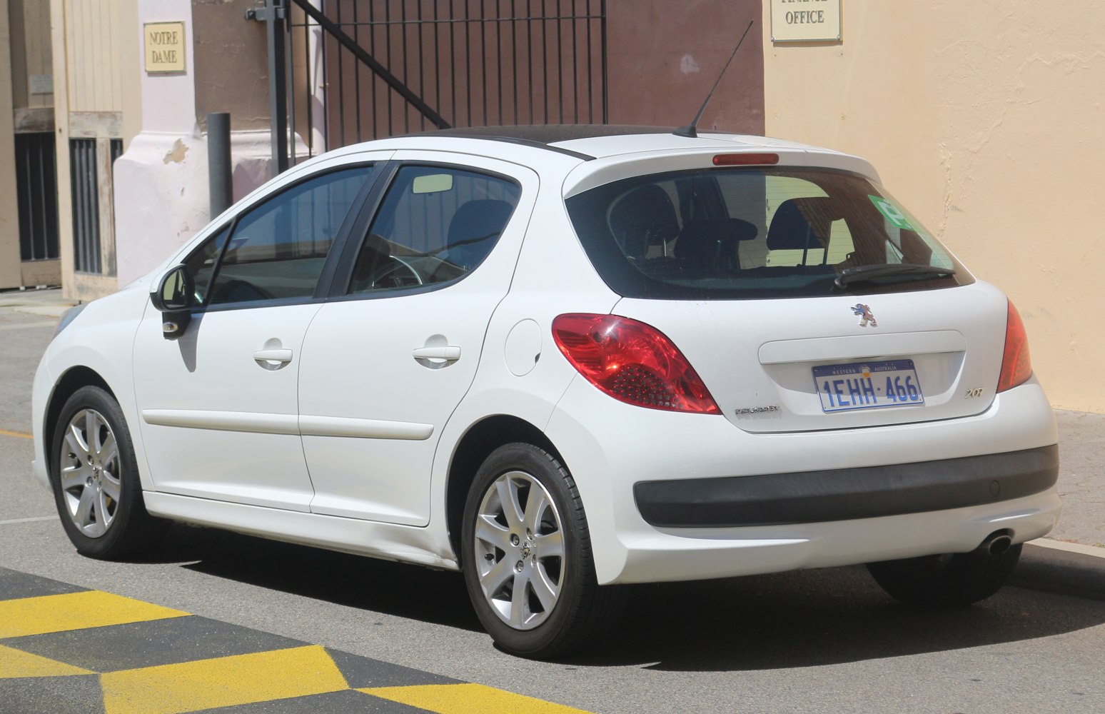 Rear-side view of a five-door hatchback with distinctive tail lights.