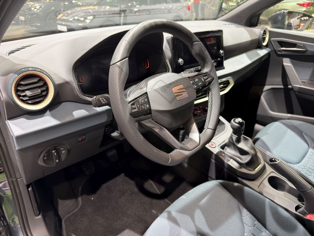 Digital instrument cluster and multifunction steering wheel with manual gear shifter