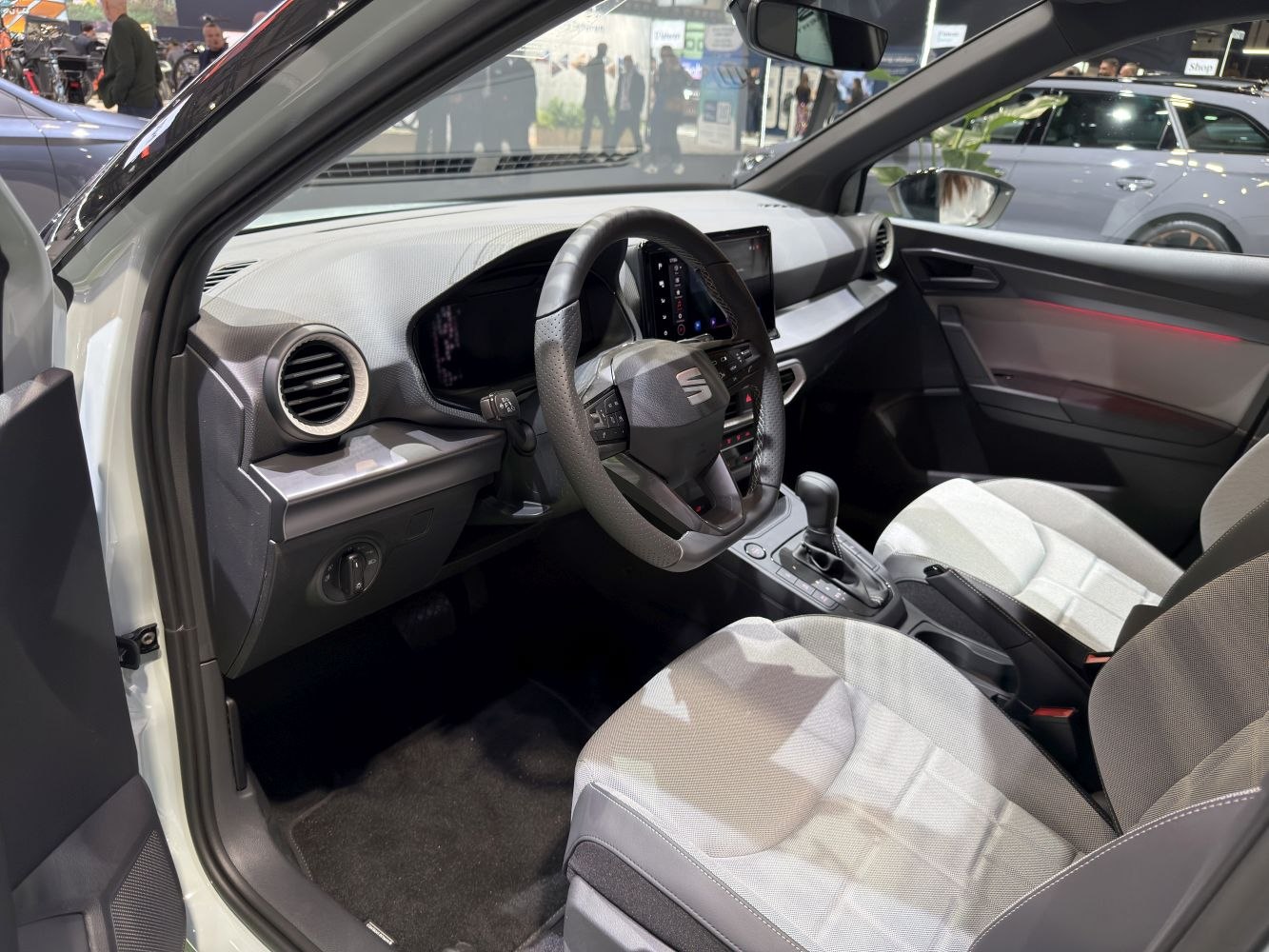 Modern steering wheel and digital instrument cluster in a compact car interior