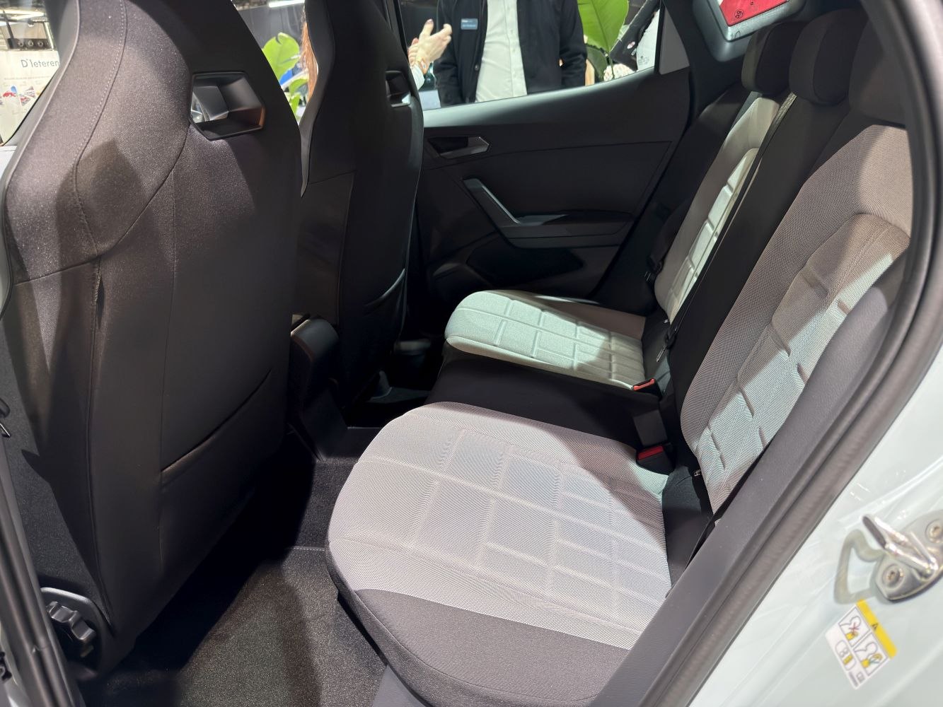 Rear seat interior with two-tone fabric upholstery and modern door design