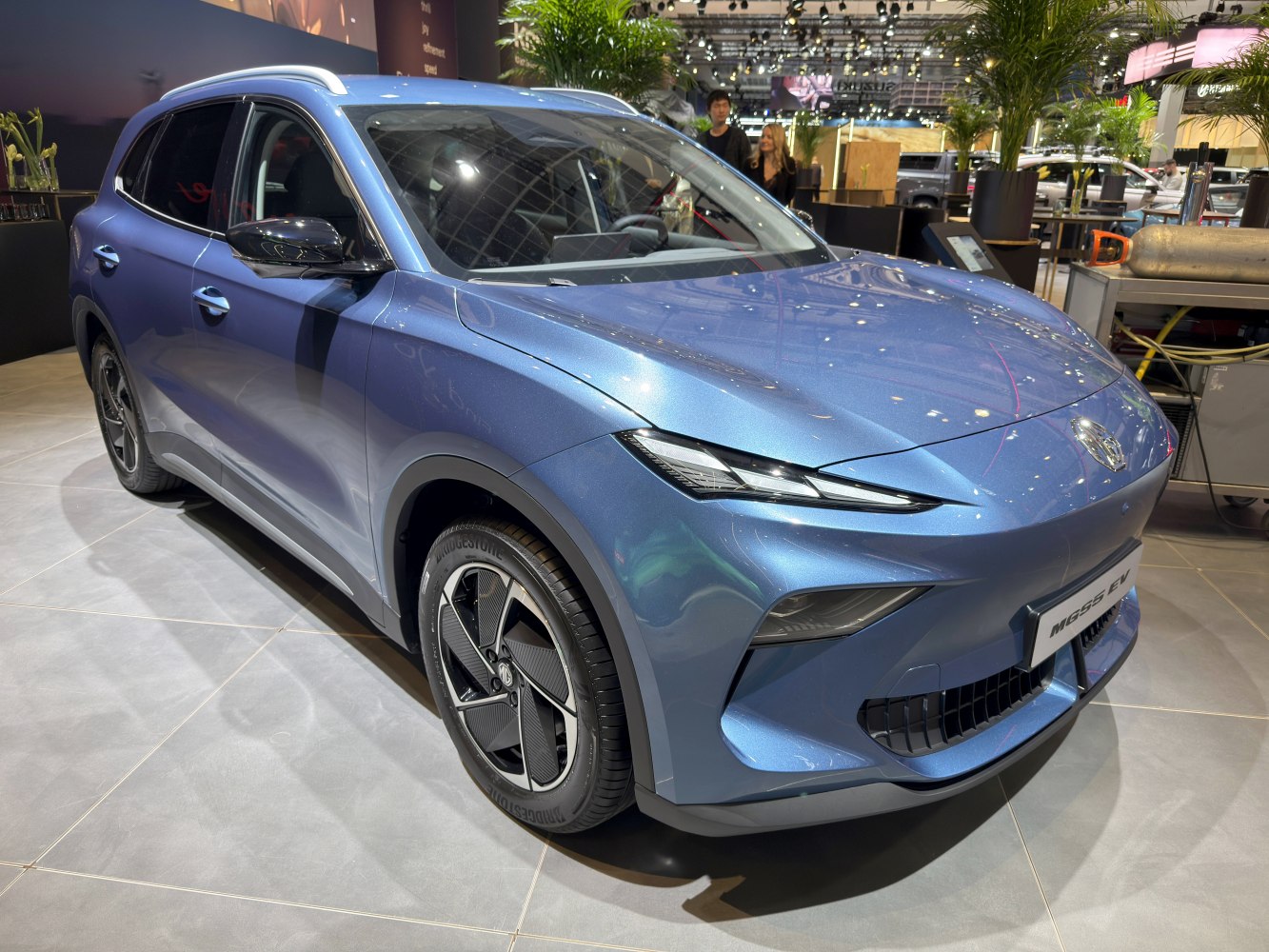 Sleek electric SUV front and side view with sharp headlights and modern rims