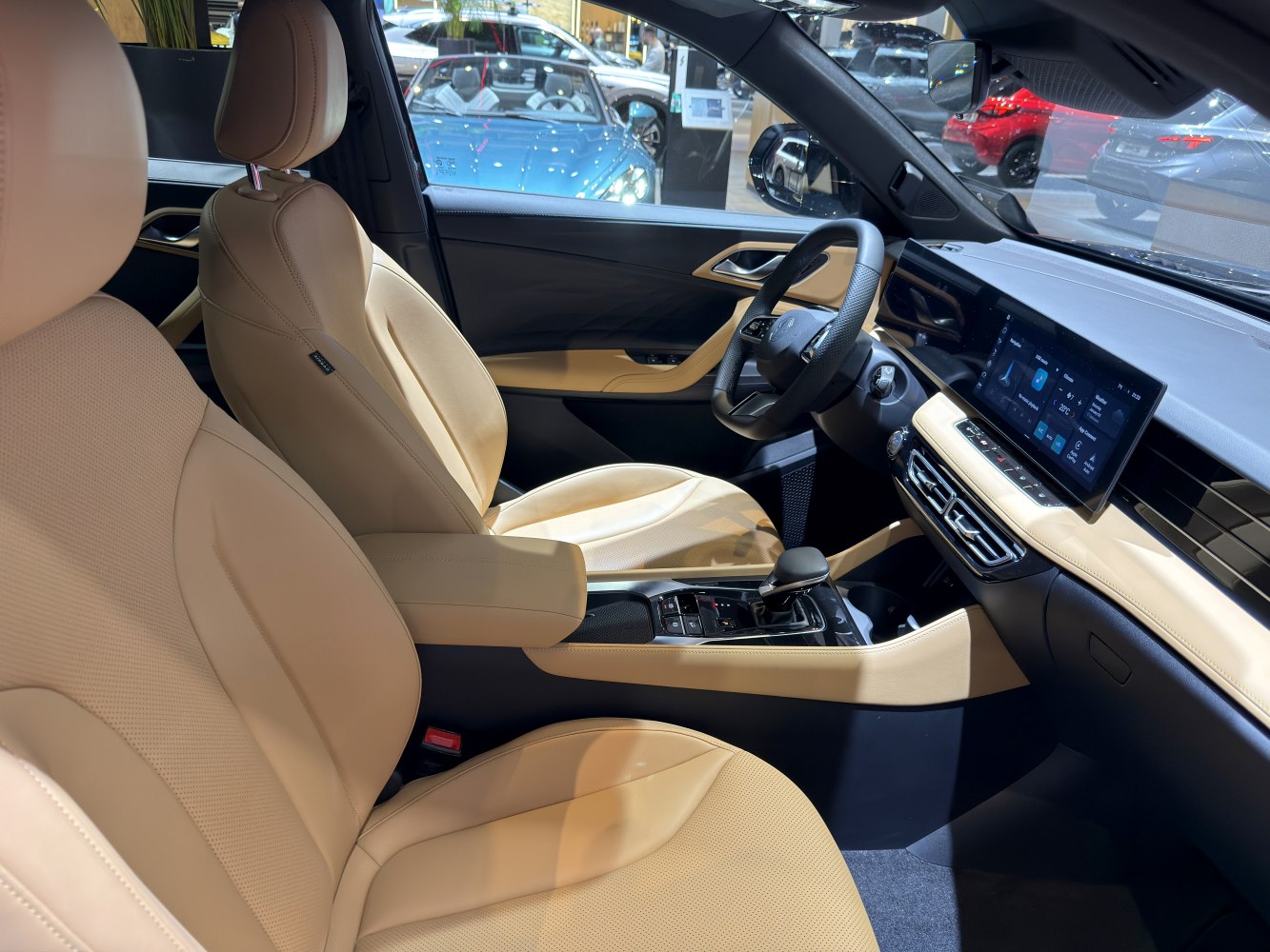 Beige leather seats and digital touchscreen dashboard in electric SUV interior