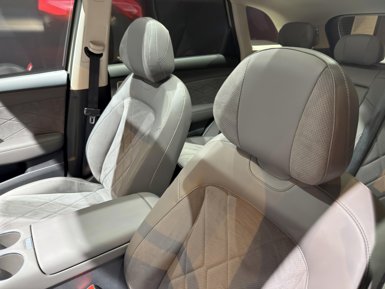 Premium leather front seats with detailed stitching and spacious interior.