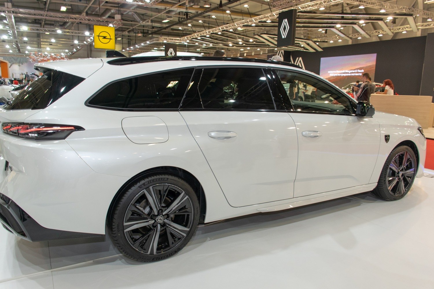 Sleek rear-side profile of station wagon with black alloy wheels