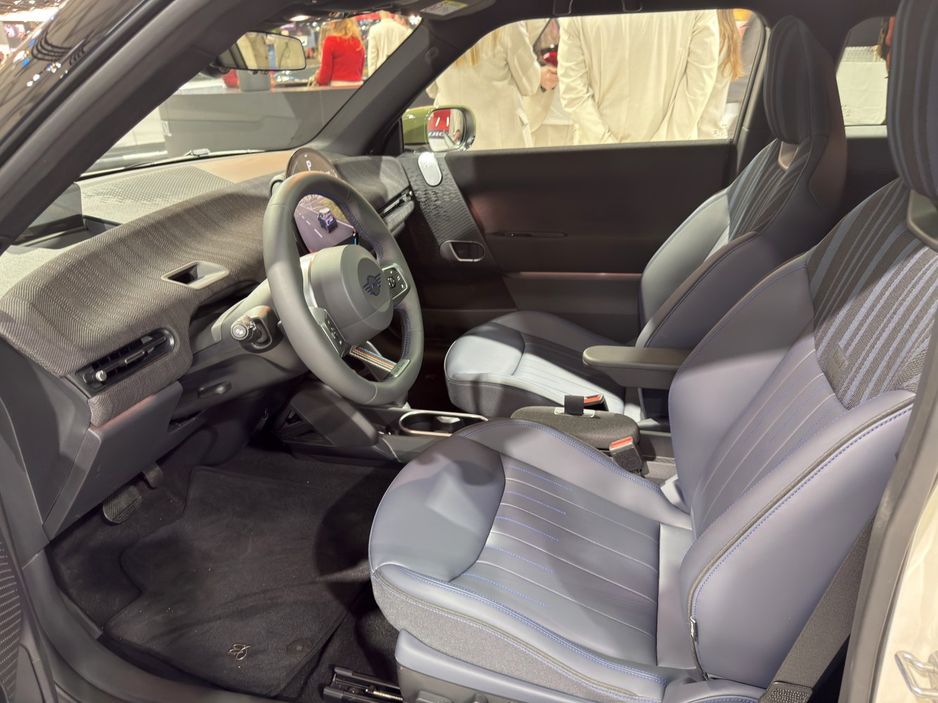 Modern dashboard and blue-accented front seats in electric vehicle