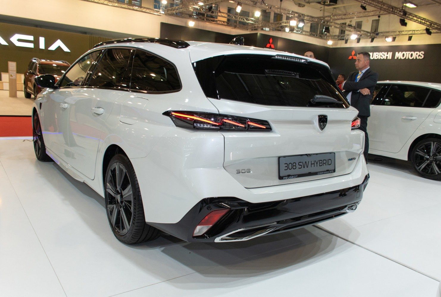 Rear three-quarter view with sleek taillights and hybrid badge