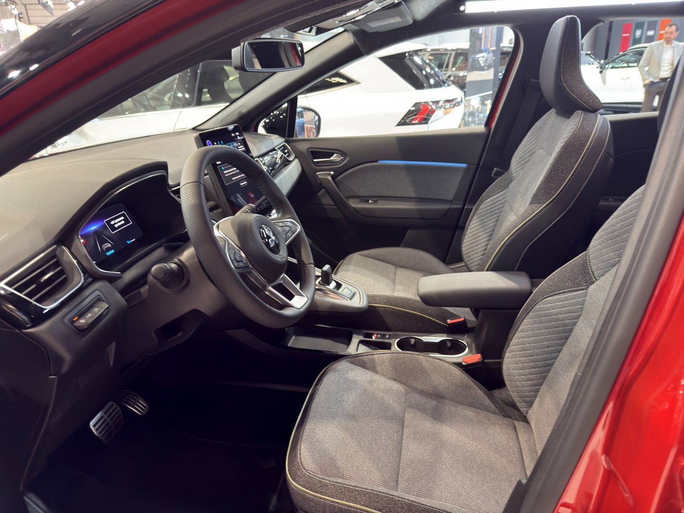 Modern digital dashboard and fabric seats with yellow stitching