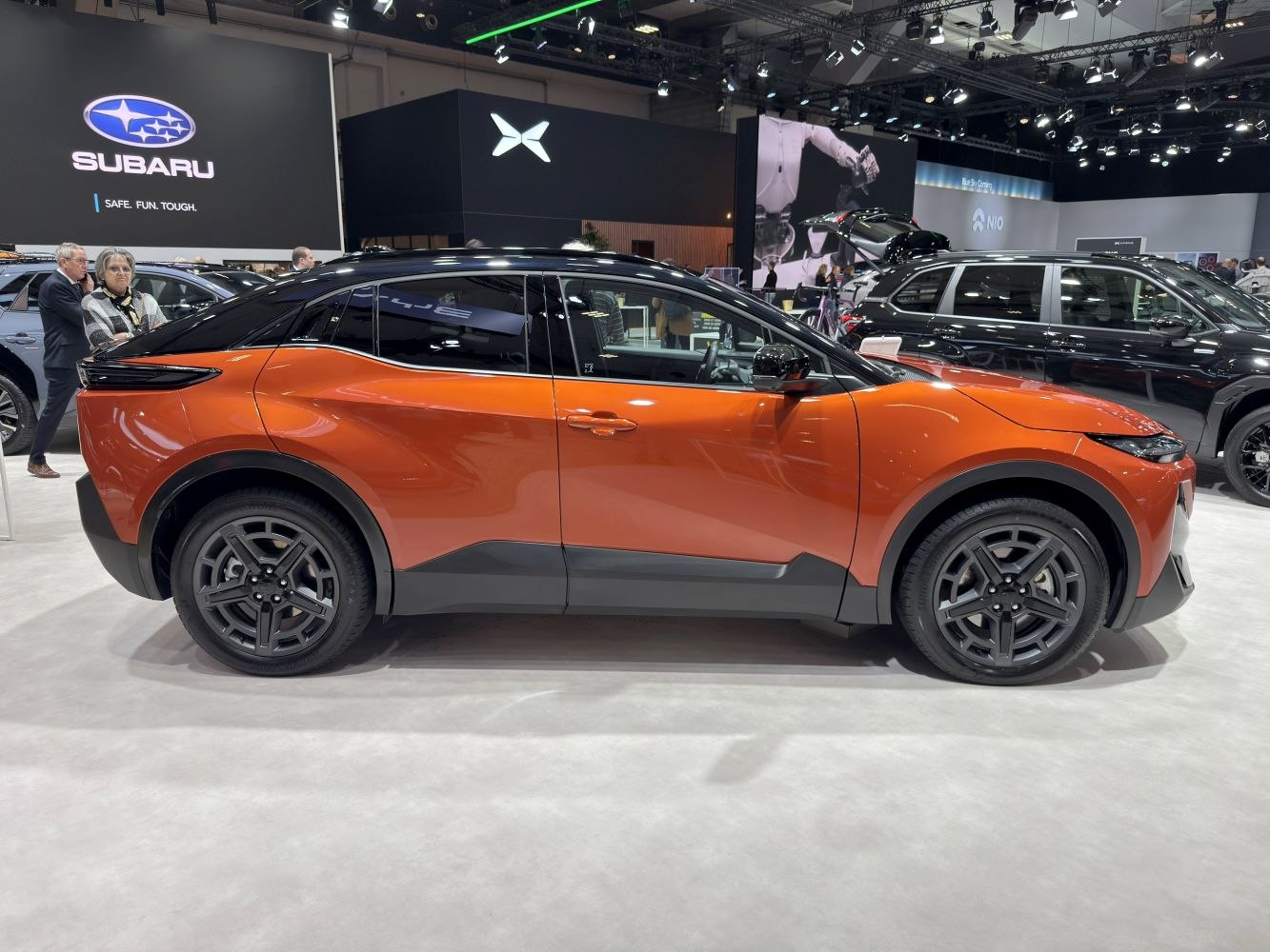 Sleek electric crossover side profile with black roof and modern wheels