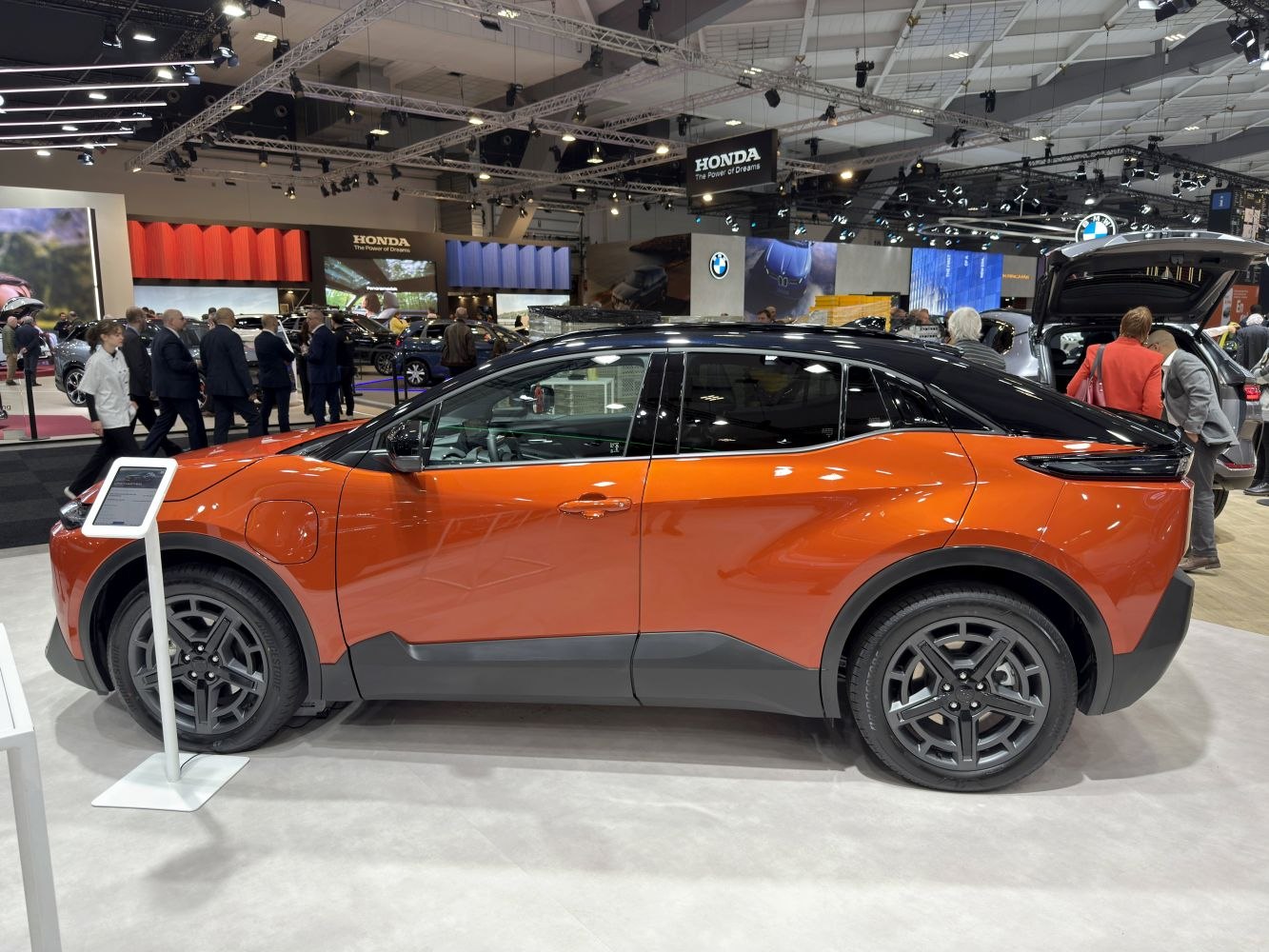 Electric crossover SUV with orange body and black roof
