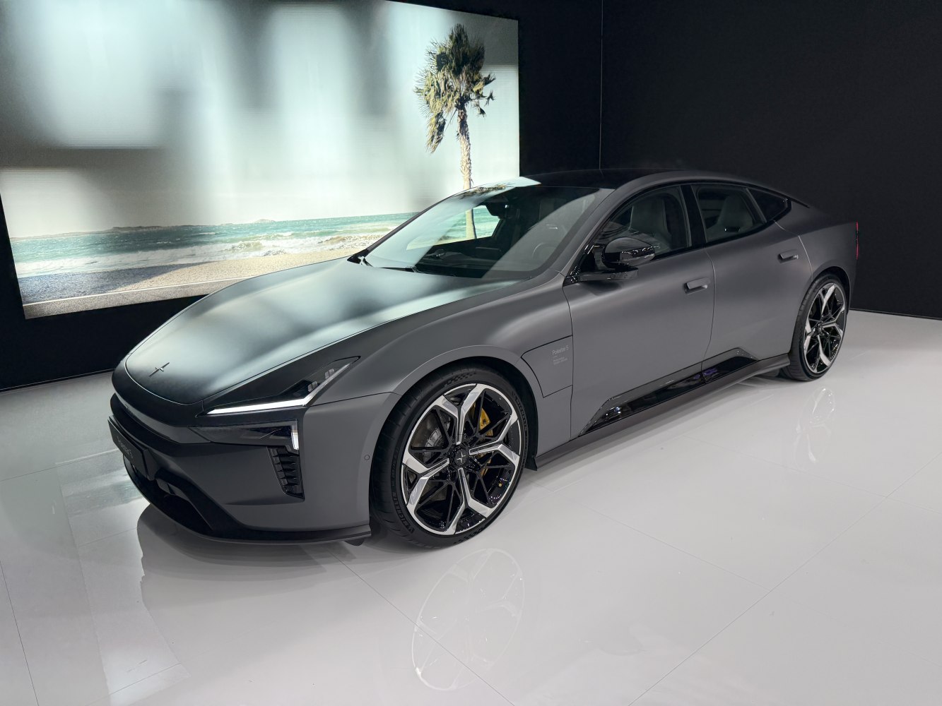 Matte-finished electric luxury sedan front side with aerodynamic design and distinct headlights