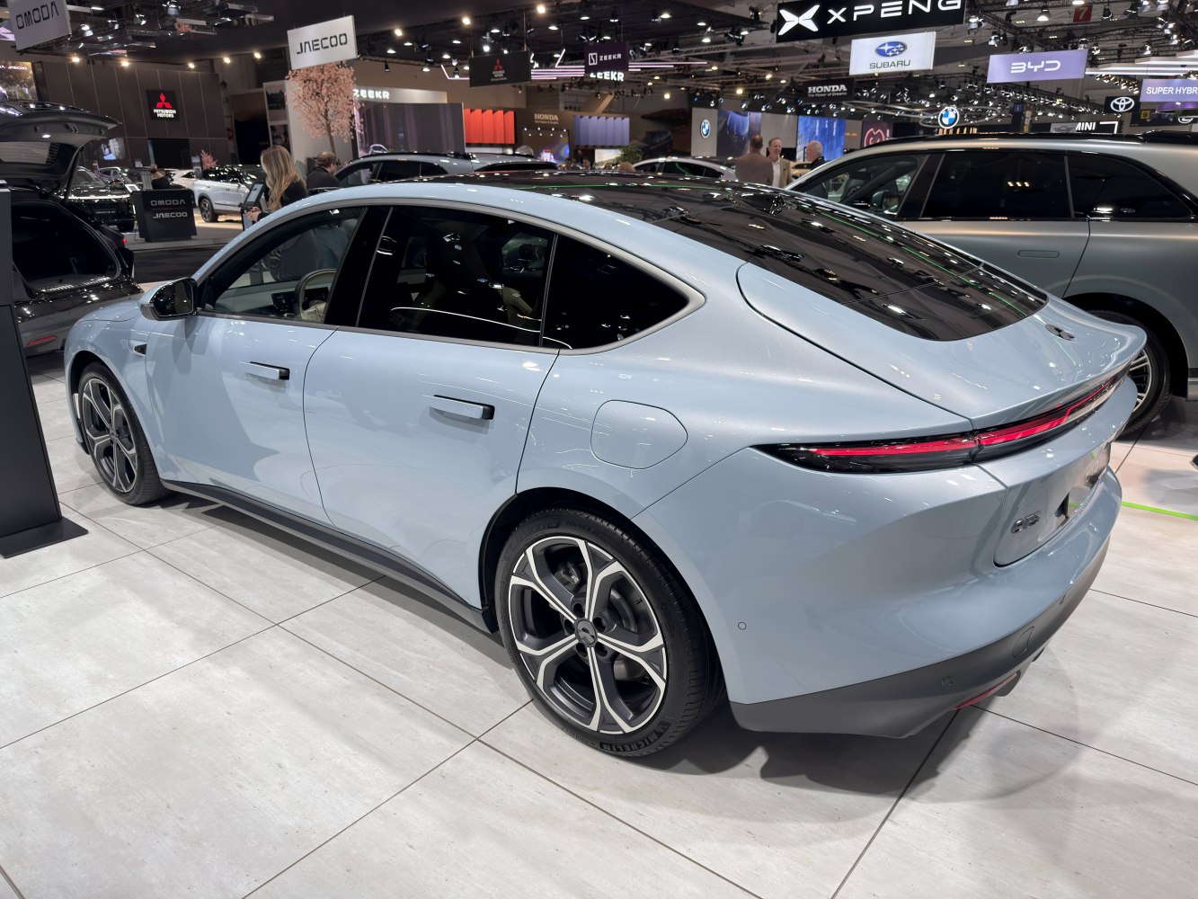 Rear profile of an electric sedan with LED tail lights and modern wheel design