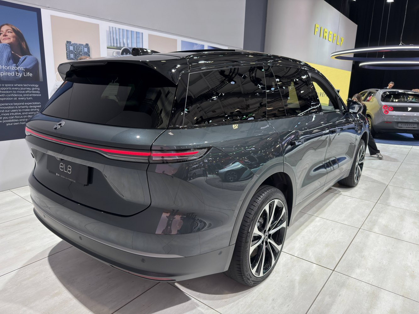 Sleek rear three-quarter view with LED tail light strip and black roof