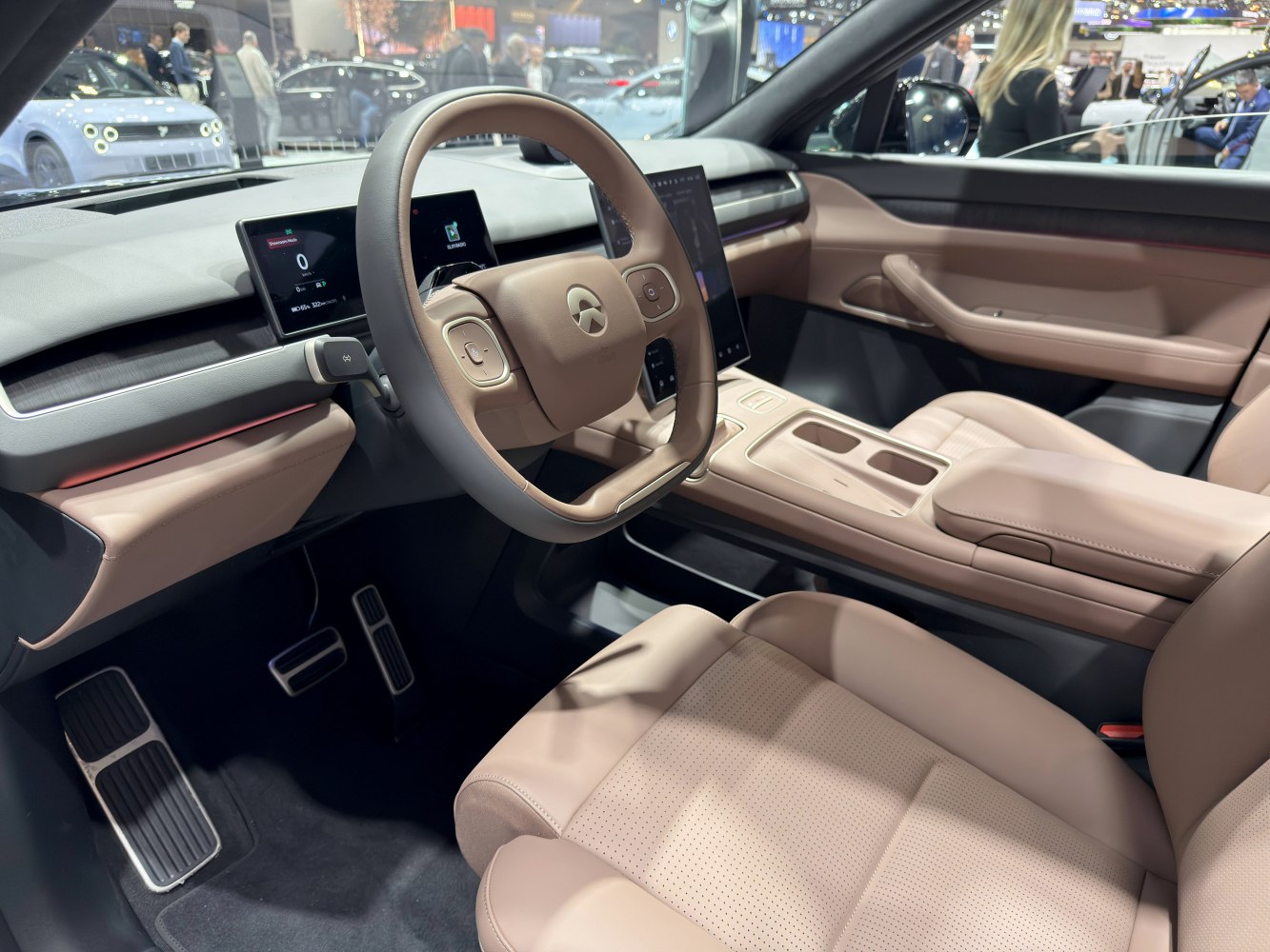 Minimalist beige interior with digital instrument cluster and touchscreen display