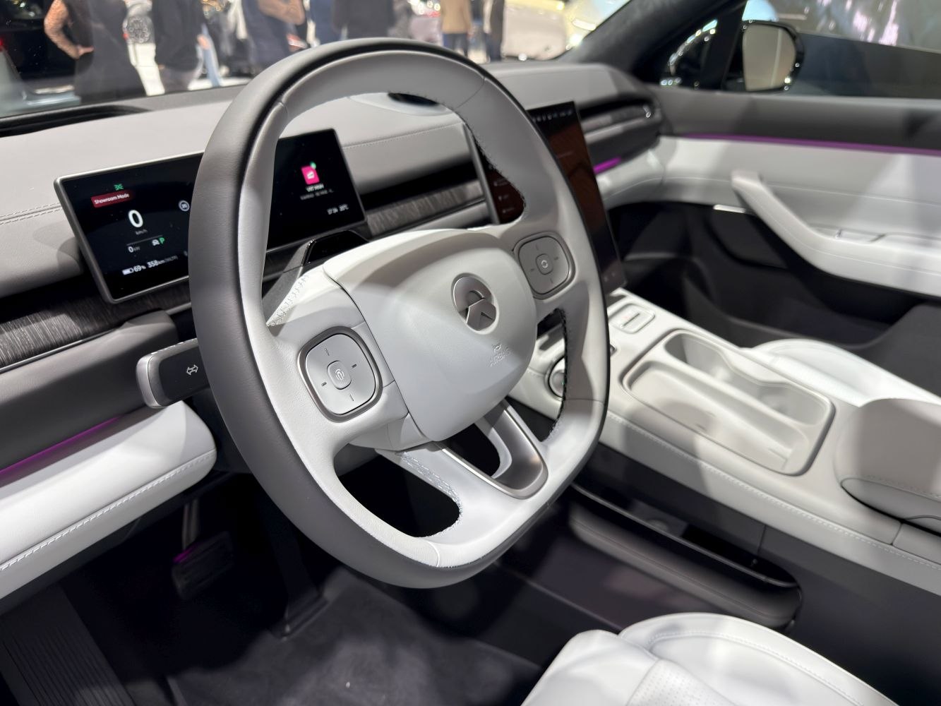 Modern electric vehicle steering wheel and digital dashboard.