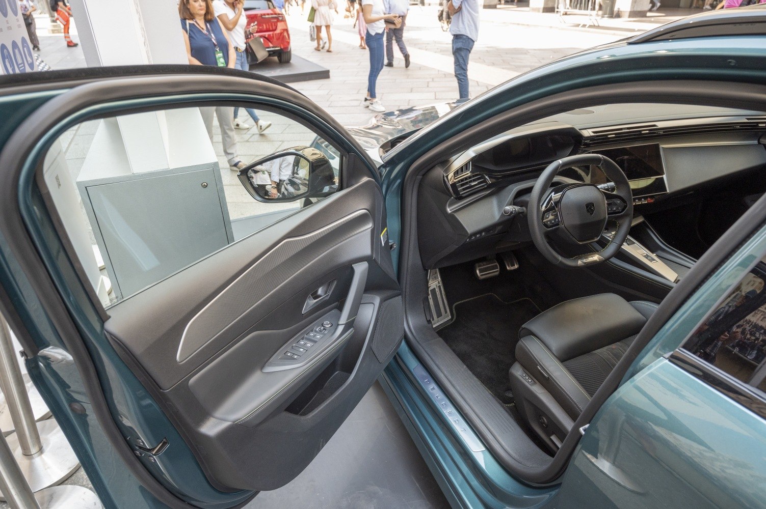 Modern car interior with dashboard, steering wheel, and door panel controls