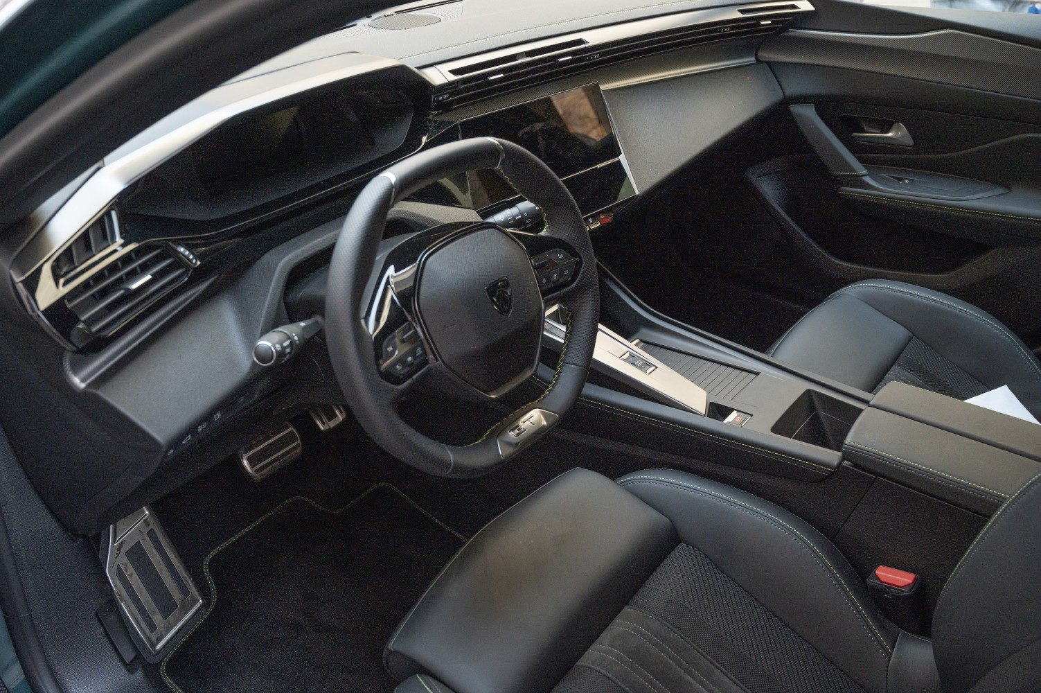 Modern steering wheel and digital dashboard in car interior
