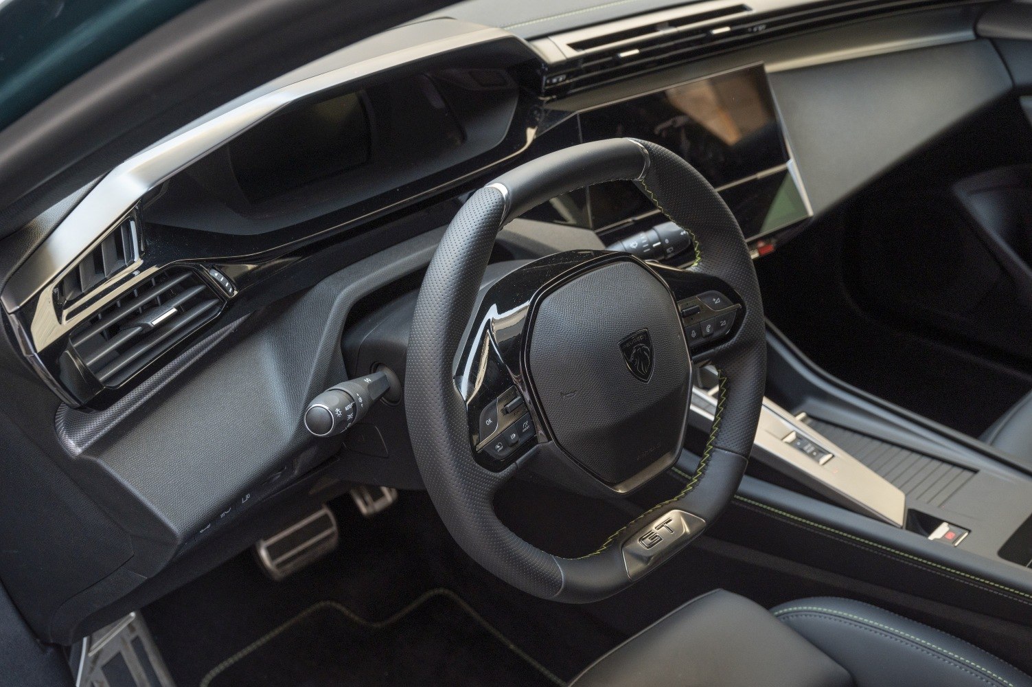 Sporty steering wheel with GT badge and digital dashboard.