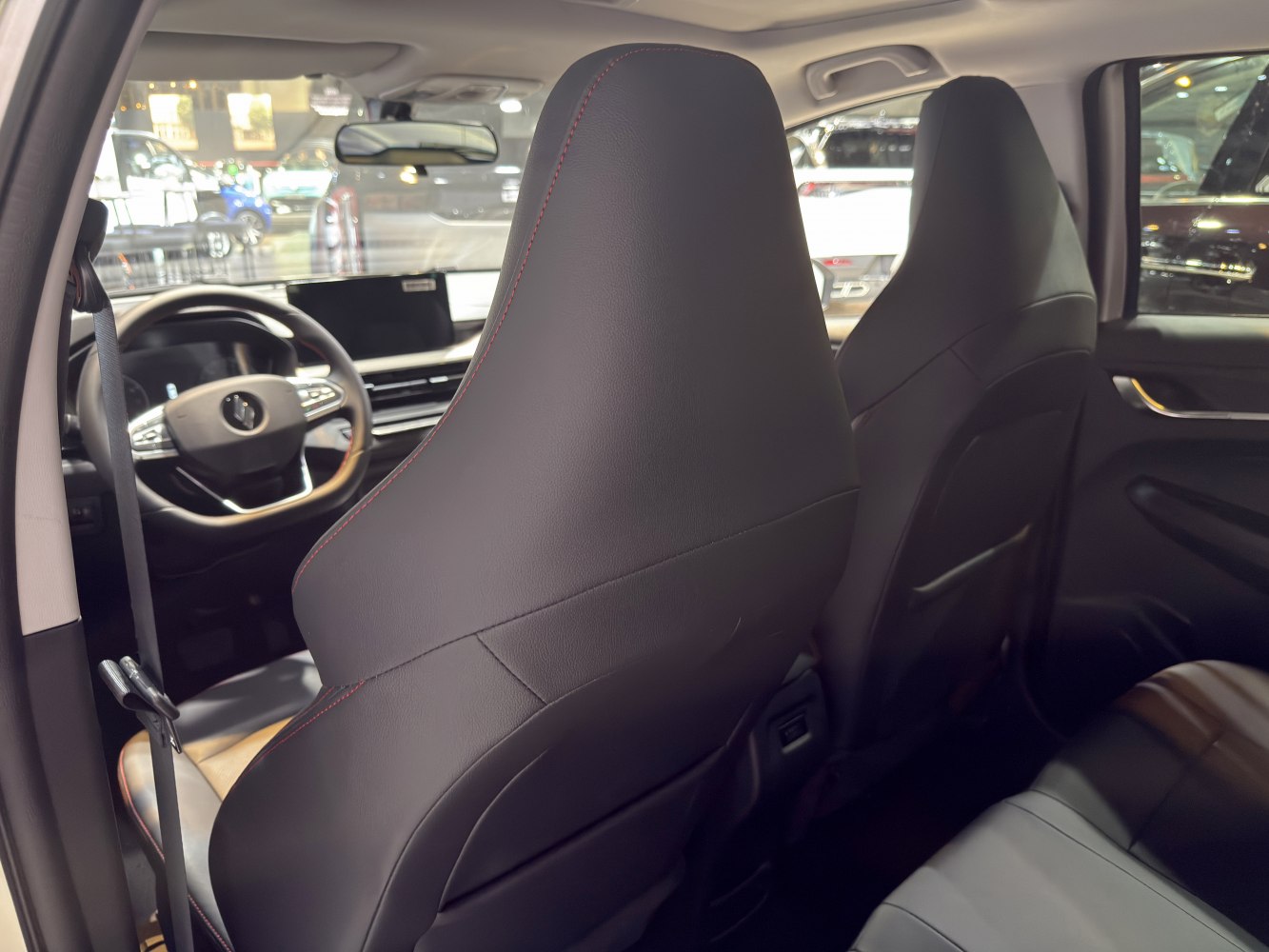 Leather front seats and modern dashboard with touchscreen display.