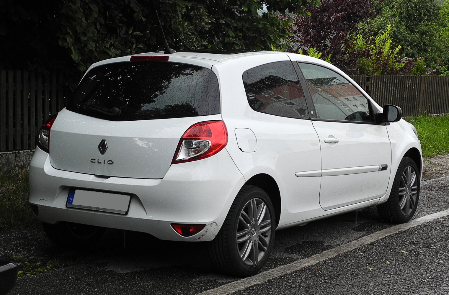 White 3-door hatchback rear-side with alloy wheels and tinted windows