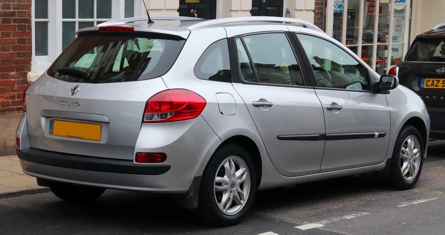 Rear and side view of silver station wagon with distinct tail lights