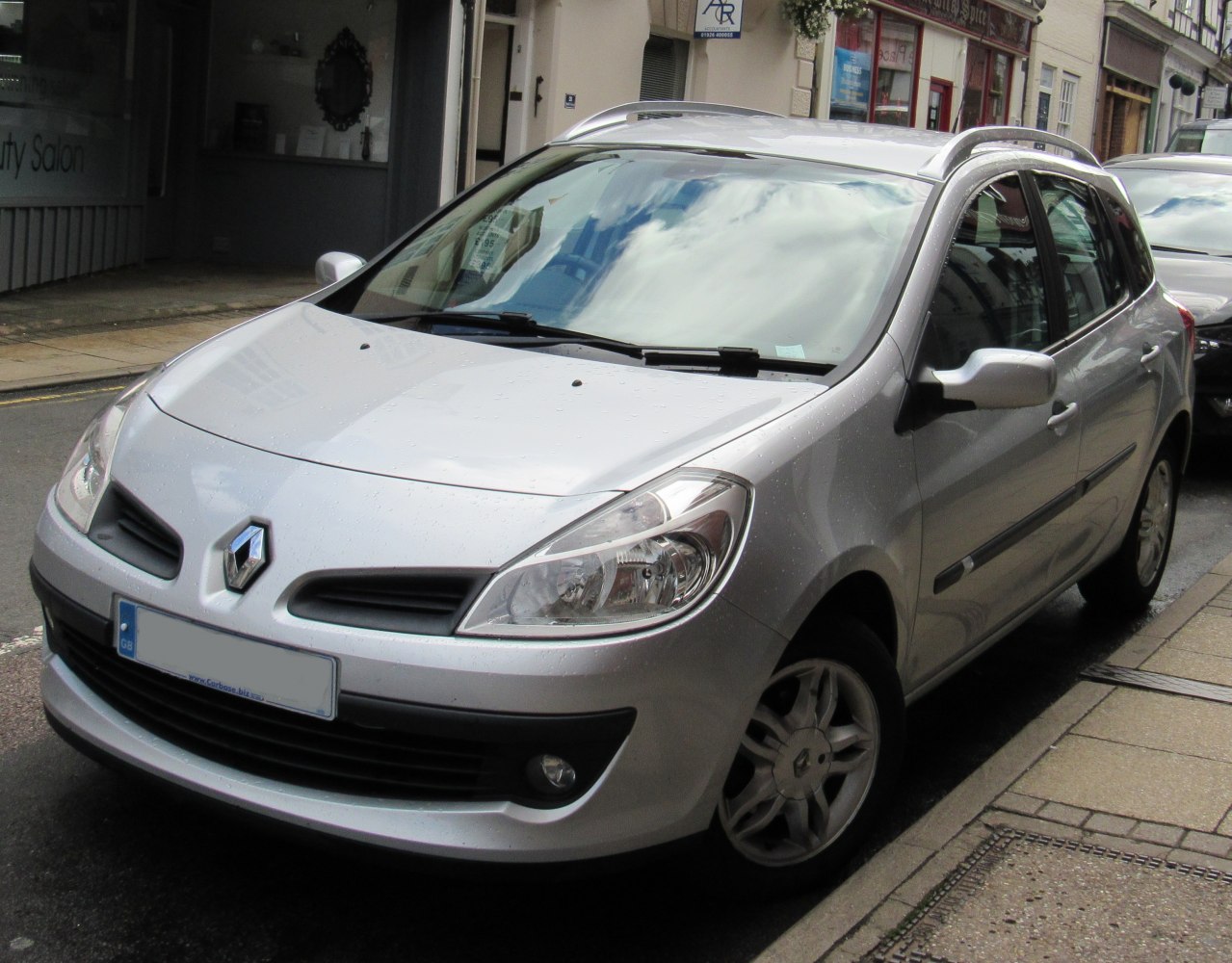 Silver compact hatchback with roof rails and alloy wheels parked on street