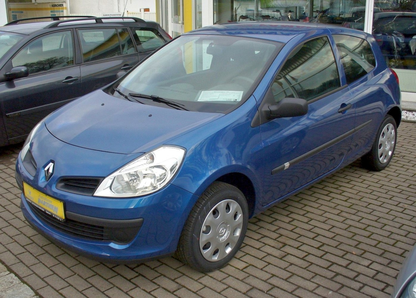Compact blue hatchback with clear headlights and 3-door design